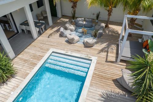an overhead view of a swimming pool on a wooden deck at Villa Zarza in Jan Thiel