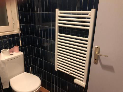 La salle de bains est pourvue de toilettes et d'un mur carrelé noir. dans l'établissement New this Year Oportoducap Villa in Cap Dagde, au Cap d'Agde