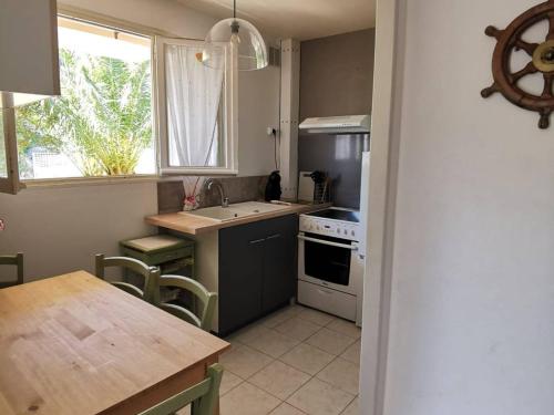 une cuisine avec un évier et une cuisinière four supérieur dans l'établissement Studio Rénové avec Grande Terrasse et Wifi à Balaruc-les-Bains - FR-1-553-230, à Balaruc-les-Bains