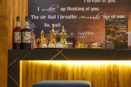 a bar with a sign on the wall and a bench at شقق سوات للشقق المخدومة 4 in Al Khobar