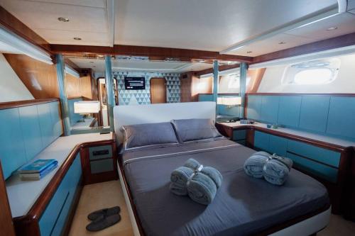 a bed in the middle of a boat with two towels at Beyond82: Luxury Yacht in Puglia in Brindisi