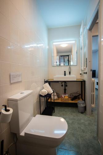 a bathroom with a white toilet and a sink at Casa Ángeles in Teruel