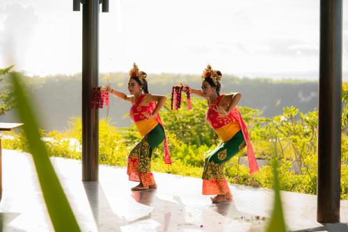 two women are performing a dance on a patio at MAUA Nusa Penida Bali in Nusa Penida