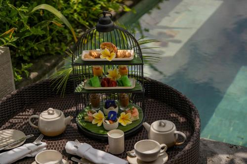 a plate of food in a bird cage on a table at MAUA Nusa Penida Bali in Nusa Penida