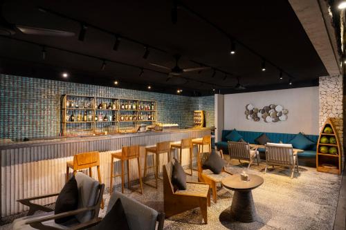 a restaurant with a bar with chairs and tables at MAUA Nusa Penida Bali in Nusa Penida