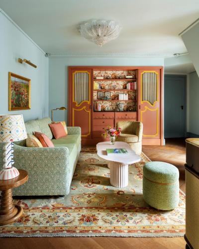 a living room with a couch and a table at Le Grand Mazarin in Paris