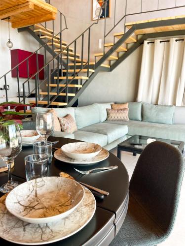 a table with plates on it in a living room at Modern Stone Villas with Swimming Pool in Aliveri