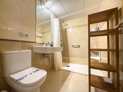a bathroom with a toilet and a sink and a shower at Penthouse by the beach in Torrox Costa