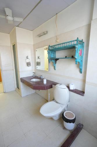 a bathroom with a toilet and a sink at DESIRE Service Apartments- CyberCity in Gurgaon