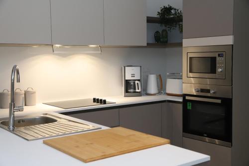 a kitchen with a sink and a counter top at Lovely holiday home next to Bus terminus in St. Paul's Bay