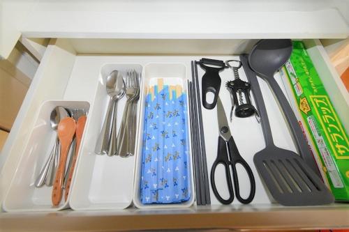 a drawer filled with utensils on a shelf at coco de minpaku in Sumiyoshi