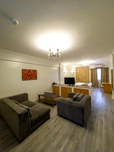 a living room with two couches and a kitchen at Maroko Bayshore Suites in Lagos