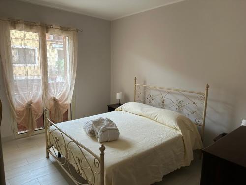a white bedroom with a bed with a white blanket at Casa dolce casa in Trecastagni