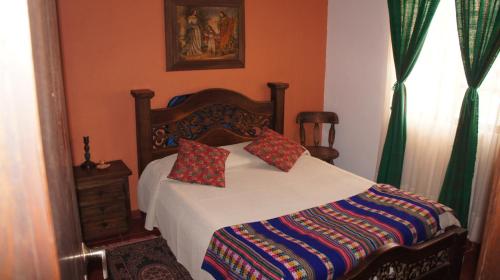 a bedroom with a bed with two pillows on it at Casa Villa de Leyva in Villa de Leyva