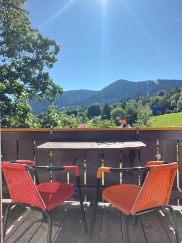 two chairs and a table on a deck at Landhaus Schönblick in Bad Kohlgrub