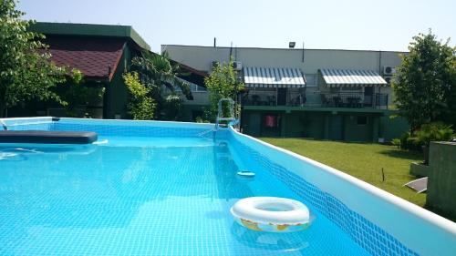 a large blue swimming pool with a white object in the water at Aheloy Apartments in Aheloy