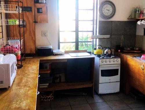 a kitchen with a stove and a counter top at Ben Your Friend Youth Foundation in Cape Town