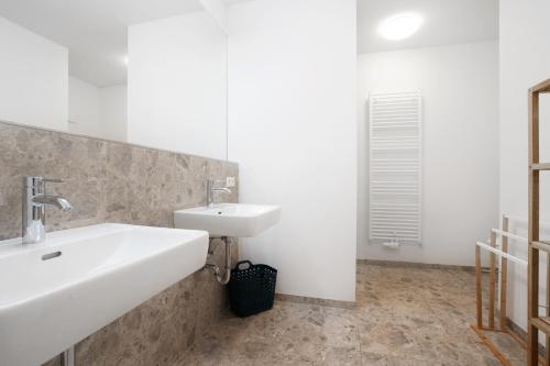 a bathroom with a white sink and a mirror at easy flat Villach main plaza in Villach