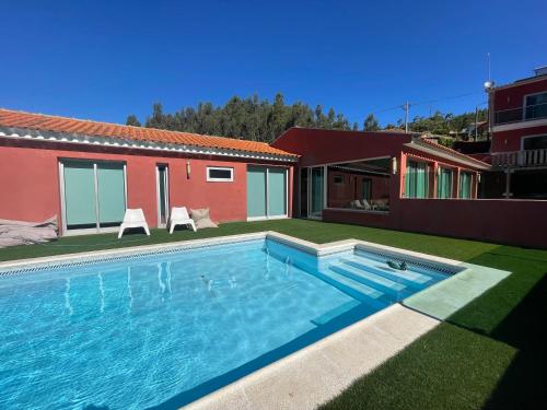 a swimming pool in the backyard of a house at Refúgio da Póvoa in Anadia