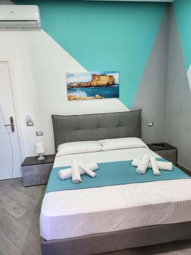 a bedroom with a bed with two pillows on it at Gradini Partenopei in Naples