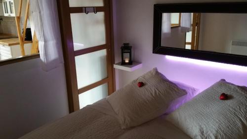 a bedroom with a mirror and a bed with two pillows at La Loge Du Vieux Lyon in Lyon