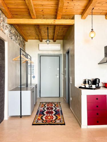 a kitchen with a door and a rug on the floor at Modern Stone Villas with Swimming Pool in Aliveri