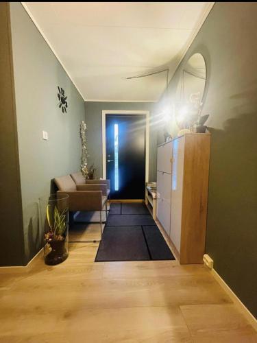 a living room with a refrigerator and a couch at Vadlåsveien 4 in Egersund