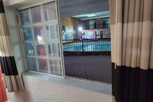 a mirror on a wall next to a swimming pool at Ramada by Wyndham Mountain Home in Mountain Home
