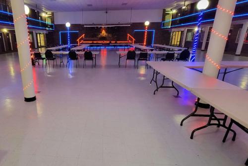 a large room with tables and chairs in a building at Ramada by Wyndham Mountain Home in Mountain Home