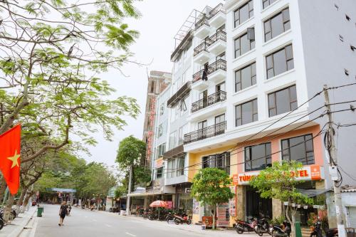 a building on a street with a chinese flag at Sea Balcony Hotel in Cat Ba