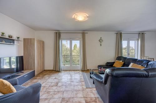 a living room with two couches and a tv at Pool House Lilly - Happy Rentals in Višnjan