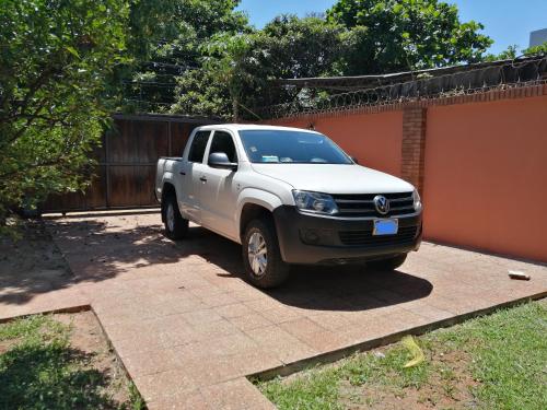 a white pickup truck parked in a driveway at BauHouse Comfort Suites Asuncion in Asuncion