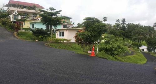 a road with a house and a fire hydrant on the side at เขาค้อออฟเลิฟ in Khao Kho