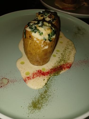 a pastry on a plate with sauce and cheese at Wellness Villa Istriana in Umag