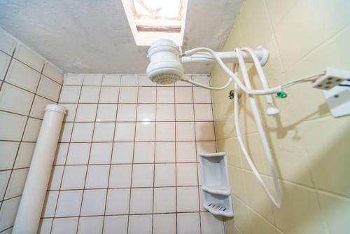 a bathroom with a urinal on a tiled wall at Hostel Multiverso in Santo André
