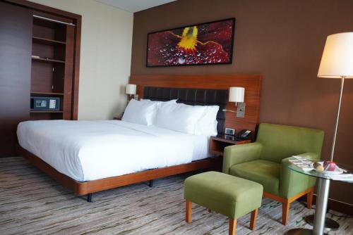 a hotel room with a bed and a chair at DoubleTree by Hilton Trabzon in Trabzon