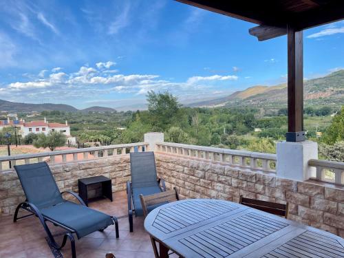 a patio with chairs and a table and a view at La casita del pueblo in Fondón
