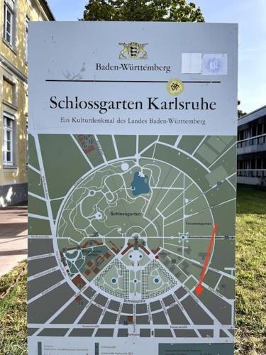 a sign with a map of a park at City Appartement direkt am Schloss! in Karlsruhe