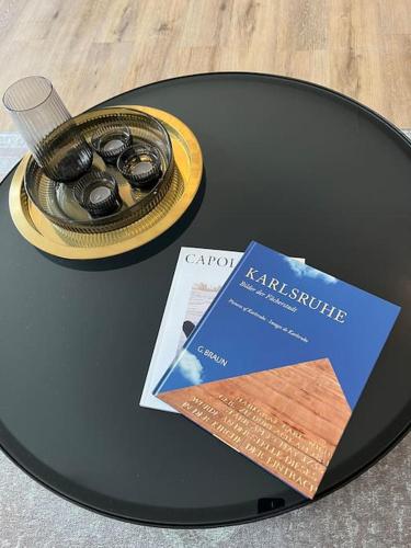 a table with a book and a pair of headphones at City Appartement direkt am Schloss! in Karlsruhe