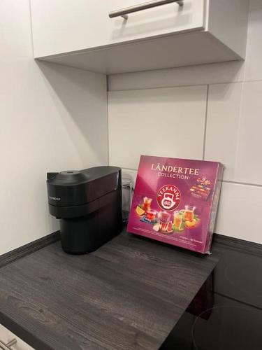 a book sitting on top of a counter in a kitchen at City Appartement direkt am Schloss! in Karlsruhe
