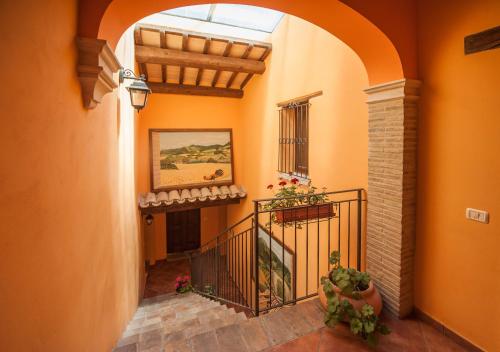 an orange hallway with an archway in a building at appartamento Colticciola Agriturismo Marche in Cagli