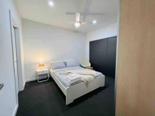 a bedroom with a bed in a white room at Lightsview Entire Apt 9 KM from CBD in Broadview
