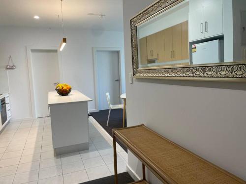 a kitchen with a counter and a mirror on the wall at Lightsview Entire Apt 9 KM from CBD in Broadview