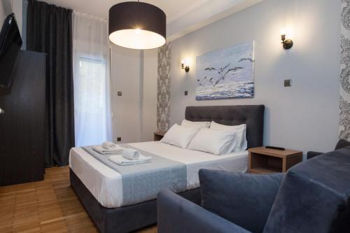 a hotel room with a bed and a couch at Metaxourgio 2 Bedroom Gem for Urban Explorers in Athens