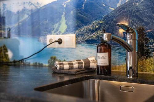 a bottle of wine sitting next to a kitchen sink at Appartements by Hofer in Kaprun