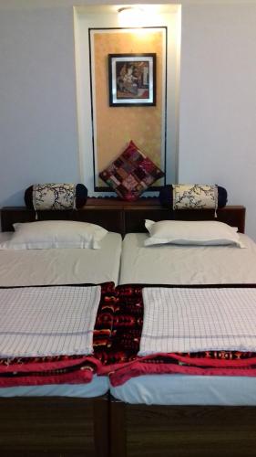 two beds sitting next to each other in a room at "Nain's Kunj" A Traveller's Home in Jodhpur