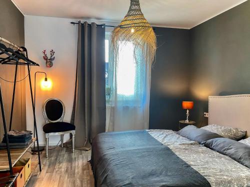 a bedroom with a bed and a chair and a window at Olivia in Tholey