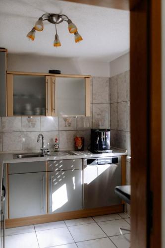 a kitchen with a sink and a counter top at Moderne Landwohnung - Pension - Top Lage in Gottmadingen