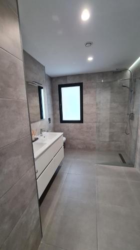 a bathroom with a tub and a sink and a shower at Moraira B5 in Moraira