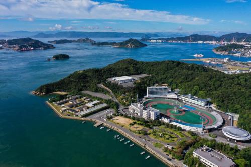 an aerial view of a golf course on a island in the water at SETOUCHI KEIRIN HOTEL 10 by Onko Chishin in Tamano